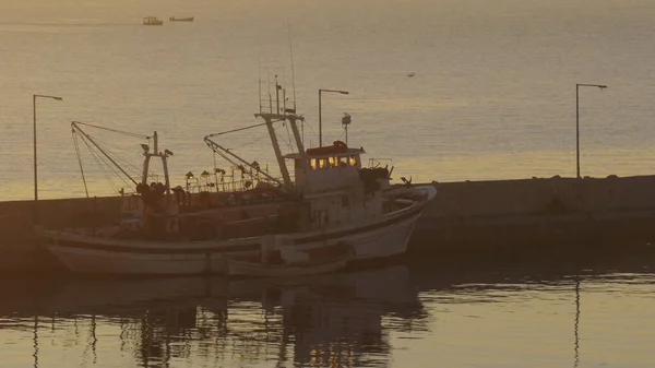 Fishing ship at anchor in sunset — Stock Photo, Image