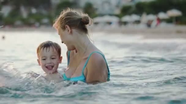 Boy With Mother In Sea — Stock Video