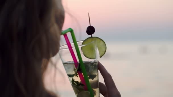 Woman drinking mojito with a straw — Stock Video