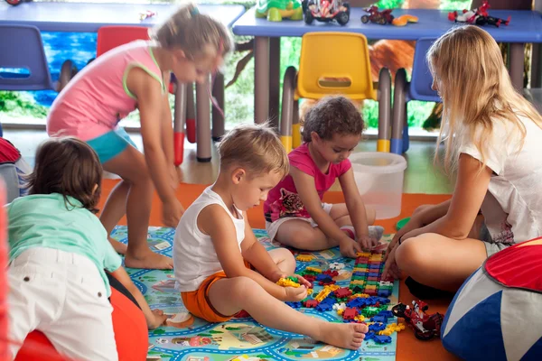 Children playing games in nursery — Stock Photo, Image