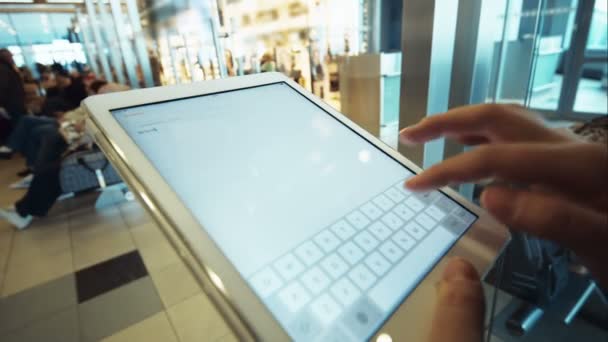 Woman using tablet PC in waiting room of airport or station — Stock Video