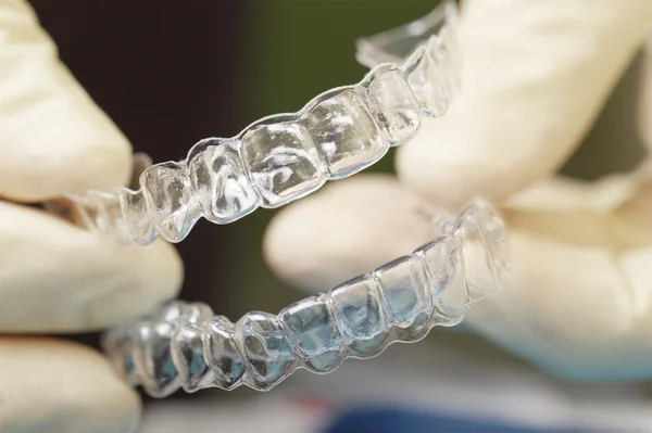 Doctors hands holding silicone mouth guard — Stock Photo, Image