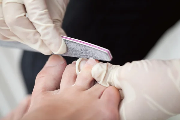 Female feet during pedicure at beauty salon — Stock Photo, Image