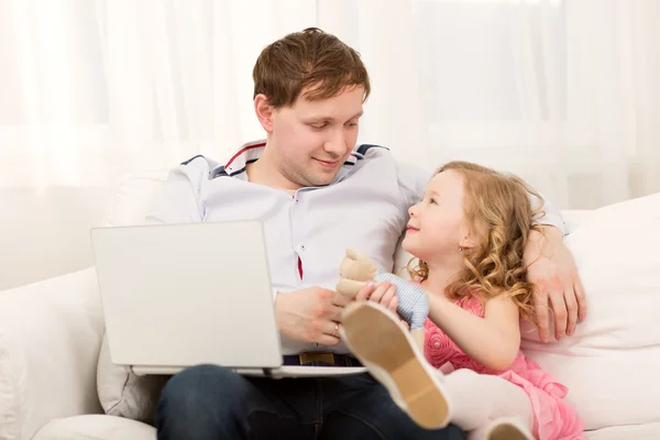 Daughter wants to play with busy dad Royalty Free Stock Images