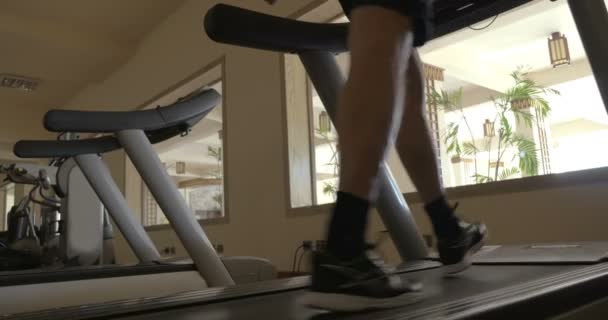 Stepping on treadmill in the gym — Stock Video