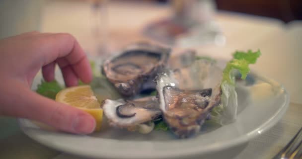 Verter jugo de limón sobre las ostras — Vídeo de stock