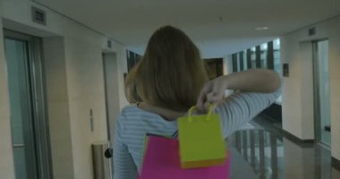 Woman with shopping bags in hotel hall