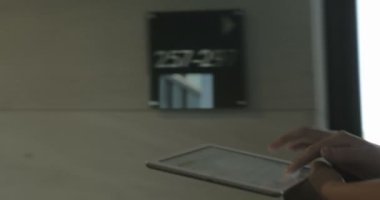 Woman using tablet PC on the go indoor