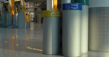 Woman throwing garbage into paper litterbin