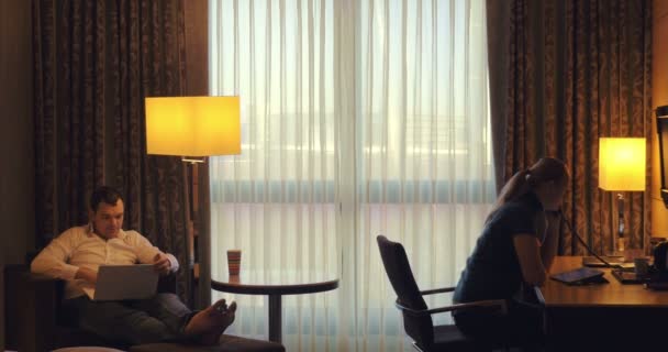 ホテルの部屋で働く若い男と女 — ストック動画