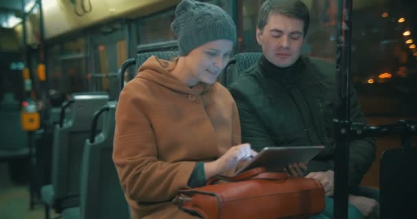 Young people using tablet computer in the bus — Stockvideo