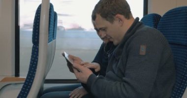 Young people entertaining with pad in the train