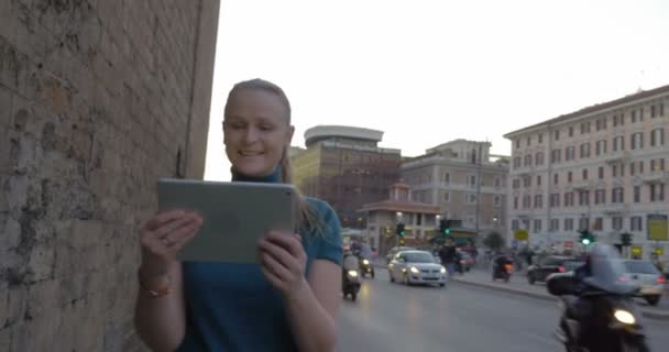 Young woman with pad having video chat outdoor — Wideo stockowe