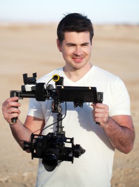 Smiling man with steadicam equipment outdoor