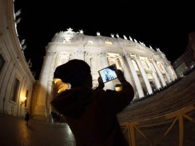 Tourist with pad shooting St. Peters Basilica in Vatican City
