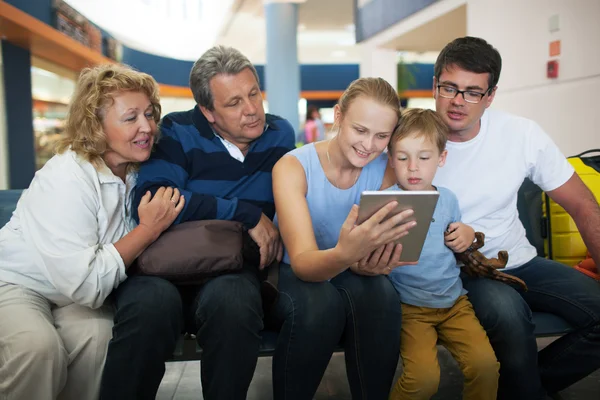 Gran familia de entretenimiento con almohadilla táctil en el aeropuerto —  Fotos de Stock