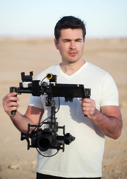 Videographer with steadicam equipment on the beach — Stock Photo, Image