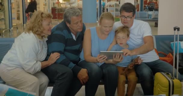 Grande família com tablet na sala de espera — Vídeo de Stock