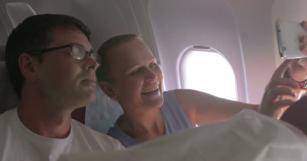 Junges Paar macht Selfie mit Handy im Flugzeug — Stockvideo