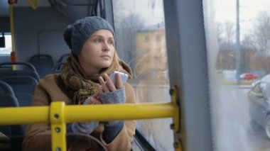 Woman with Smartphone Riding a Bus