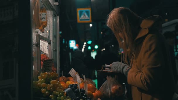 Жінка купує фрукти на вулиці — стокове відео