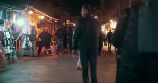 Calle veneciana con gente y mesas expendedoras por la noche — Vídeos de Stock