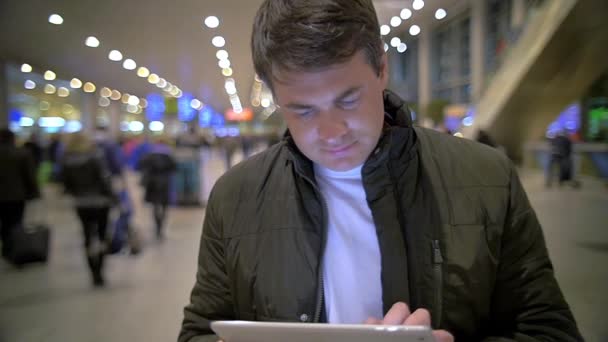 Hombre usando tableta electrónica en la estación — Vídeos de Stock