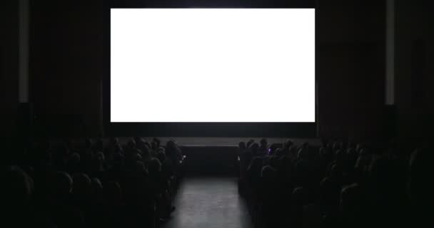 Προβολείς σε σκοτεινή αίθουσα κινηματογράφου με λευκή οθόνη — Αρχείο Βίντεο