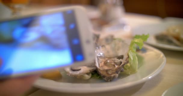 Taking shots of oysters with smart phone — Stock Video