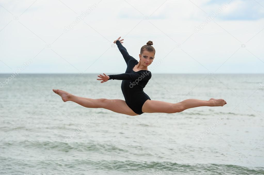Gymnast Dancer Jumping On The Sea Beach — Stock Photo © danr13 #83899074