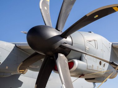 Aerodinamik bıçak dizaynını ve motor motor motorunun güneş ışığı altında hatlarını gösteren pervane montajının yakın çekimi