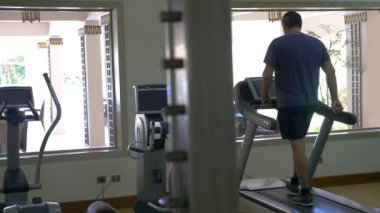 Working out on treadmill in modern gym
