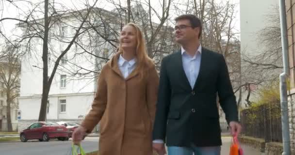 Elegante hombre y mujer caminando después de ir de compras — Vídeos de Stock