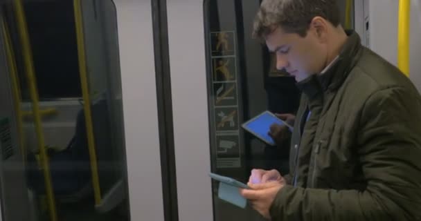 Commuter with pad in underground train — Stock Video
