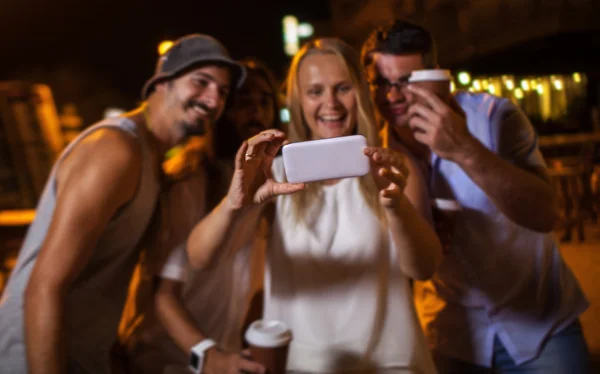 Happy friends making phone selfie at night — Stockfoto