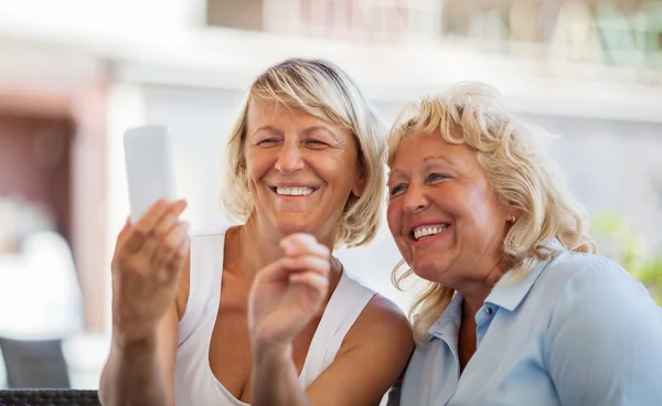 Modern mature women making happy mobile selfie — Stock Photo, Image