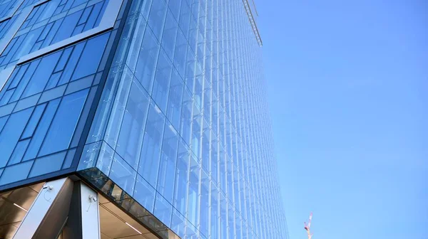 Facade texture of a glass mirrored office building. Fragment of the facade. Modern architecture of the office building.