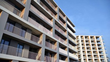 Balkonları olan modern bir apartmanın ön cephesi. İnsan yok. Emlak işi kavramı.