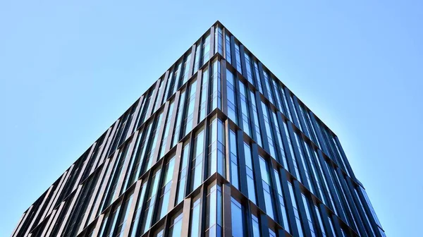 Glass facade of the buildings with a blue sky. Skyscrapers in the business city center.. Background of modern glass buildings.