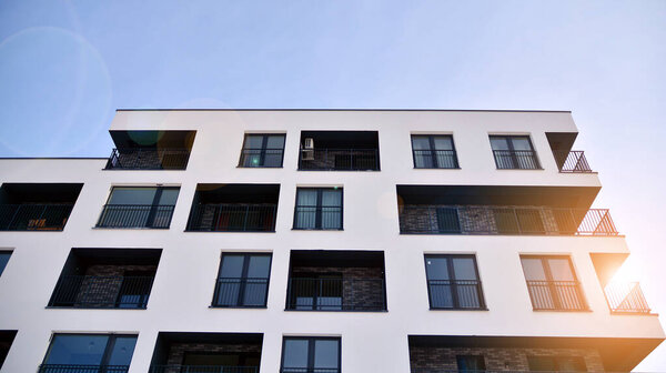 Modern apartment buildings on a sunny day with a blue sky. Facade of a modern apartment building.Glass surface with sunlight.