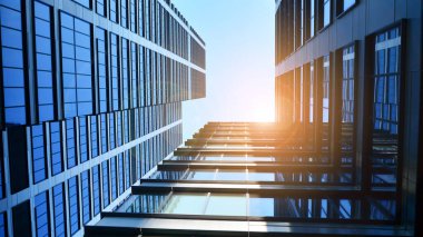 Mavi gökyüzüne karşı modern gökdelenlerin alt manzarası. Şehir merkezindeki iş binalarına bakıyorum. Ufukta yükselen güneş.