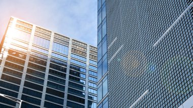 Yansıtıcı camlarla kaplı modern bir binanın cam ön cephesi..