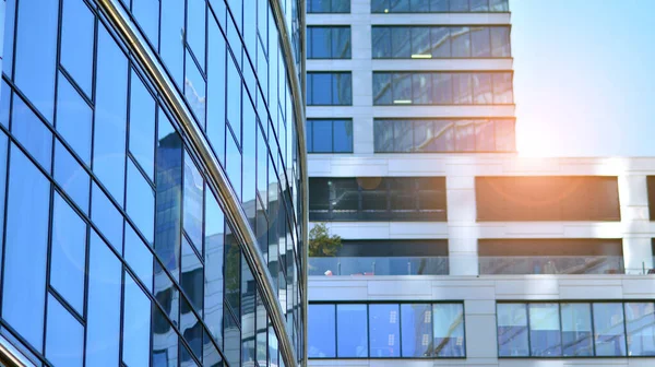 Glass facade of the buildings with a blue sky. Skyscrapers in the business city center.. Background of modern glass buildings.