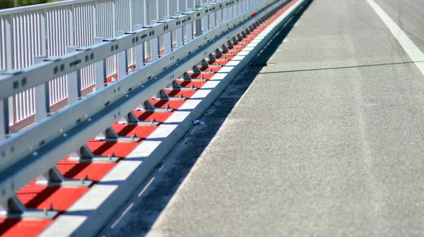 Safety barriers on the highway. Anodized safety steel barrier on freeway bridge.