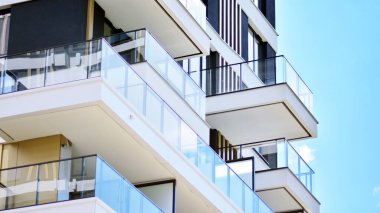 Detail in modern residential flat apartment building exterior. Condominium and apartment building with  symmetrical modern architecture. 