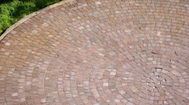 Rough surface with curving shapes. Place made from brick red abstract background.