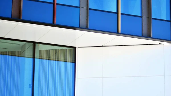 Glass facade of the buildings with a blue sky. Modern building in the business city center. Background of modern glass buildings.