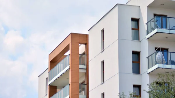 New apartment building with glass balconies. Modern architecture houses by the sea. Large glazing on the facade of the building.