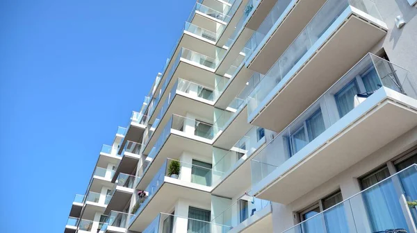 New apartment building with glass balconies. Modern architecture houses by the sea. Large glazing on the facade of the building.