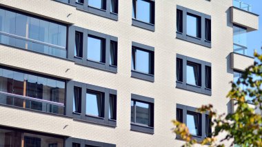 Ekolojik konut mimarisi. Ağaçların çevresindeki modern bir yerleşim yeri. Ekoloji ve yeşil yaşam şehirde, kentsel çevre kavramı. Modern apartman ve yeşil ağaçlar.